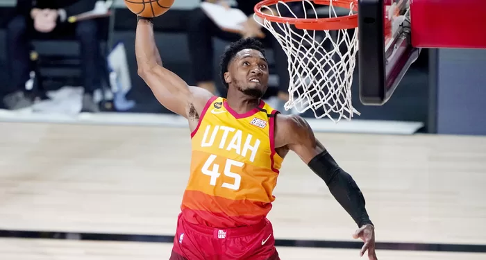LAKE BUENA VISTA, FLORIDA - AUGUST 21: Donovan Mitchell #45 of the Utah Jazz dunks against the Denver Nuggets during the second half of Game Three of first round playoffs at the AdventHealth Arena at the ESPN Wide World Of Sports Complex on August 21, 2020 in Lake Buena Vista, Florida. NOTE TO USER: User expressly acknowledges and agrees that, by downloading and or using this photograph, User is consenting to the terms and conditions of the Getty Images License Agreement. (Photo by Ashley Landis-Pool/Getty Images)