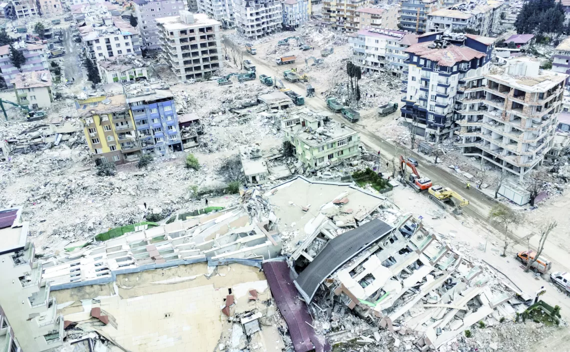 epa10481769 An aerial view taken with a drone shows, a view of collapsed buildings after a powerful earthquake in Hatay, Turkey, 21 February 2023. More than 46,000 people have died and thousands more are injured after two major earthquakes struck southern Turkey and northern Syria on 06 February.  EPA/ERDEM SAHIN