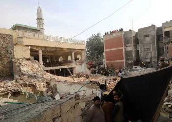 epa10440922 Rescue workers search for victims amid debris a day after a suicide bomb blast at a Mosque in Police Lines, in Peshawar, KPK province, Pakistan, 31 January 2023. The death toll from the suicide bombing has reached 92, police said on 31 January. Most of the deceased in the  attack, one of the deadliest ever staged on law enforcement authorities in Pakistan's history, are police and other members of the security forces.  EPA/ARSHAD ARBAB