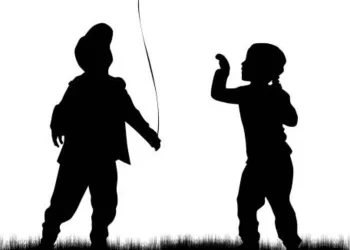Silhouette of children with balloon.