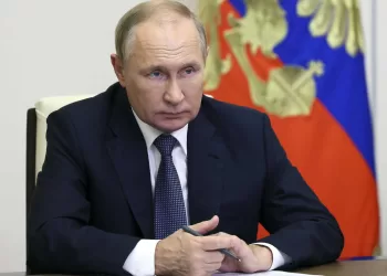 FILE - Russian President Vladimir Putin speaks to Governor of Magadan Region Sergey Nosov via videoconference at the Novo-Ogaryovo residence outside Moscow, Russia, on Oct. 21, 2022. The International Criminal Court said Friday, March 17, 2023 it has issued an arrest warrant for Russian President Vladimir Putin for war crimes because of his alleged involvement in abductions of children from Ukraine. (Gavriil Grigorov, Sputnik, Kremlin Pool Photo via AP)