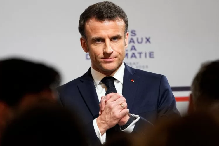 TOPSHOT - French President Emmanuel Macron reacts during the National Roundtable on Diplomacy at the Foreign Ministry in Paris on March 16, 2023. - Frances Foreign Ministry is undertaking a sweeping review of its vast diplomatic corps, an effort driven by President Emmanuel Macron to adapt French diplomacy to 21st century challenges. (Photo by Michel Euler / POOL / AFP) (Photo by MICHEL EULER/POOL/AFP via Getty Images)