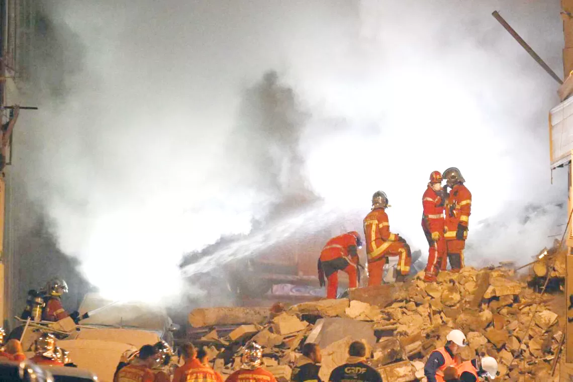CORRECTION / Rescue personnel work at the scene where a building collapsed in the southern French port city of Marseille  early on April 9, 2023. - A building in the southern French port city of Marseille collapsed, police told AFP early on April 9, though it was unclear whether there were any victims. (Photo by NICOLAS TUCAT / AFP) / The erroneous mention[s] appearing in the metadata of this photo by NICOLAS TUCAT has been modified in AFP systems in the following manner: [April 9] instead of [March 9]. Please immediately remove the erroneous mention[s] from all your online services and delete it (them) from your servers. If you have been authorized by AFP to distribute it (them) to third parties, please ensure that the same actions are carried out by them. Failure to promptly comply with these instructions will entail liability on your part for any continued or post notification usage. Therefore we thank you very much for all your attention and prompt action. We are sorry for the inconvenience this notification may cause and remain at your disposal for any further information you may require.