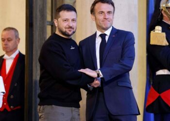 Ukraine's President Volodymyr Zelensky (L) is welcomed by France's President Emmanuel Macron (c) upon his arrival at the Elysee presidential palace in Paris on May 14, 2023. (Photo by Ludovic MARIN / AFP)