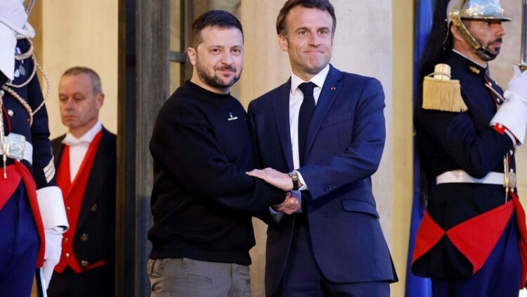 Ukraine's President Volodymyr Zelensky (L) is welcomed by France's President Emmanuel Macron (c) upon his arrival at the Elysee presidential palace in Paris on May 14, 2023. (Photo by Ludovic MARIN / AFP)