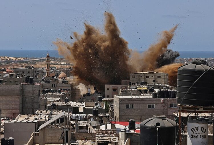 A targeted building is hit during an Israeli airstrike in Rafah in the southern Gaza Strip on May 20, 2021. - Israel and the Palestinians are mired in their worst conflict in years as Israel pounds the Gaza Strip with air strikes and artillery, while Hamas militants fire rockets into the Jewish state. (Photo by SAID KHATIB / AFP)