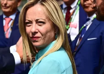 Italian Prime Minister Giorgia Meloni (C) looks on prior to the start of the Italian Formula One Grand Prix race at Autodromo Nazionale Monza circuit, in Monza on September 3, 2023. (Photo by Marco BERTORELLO / AFP)
