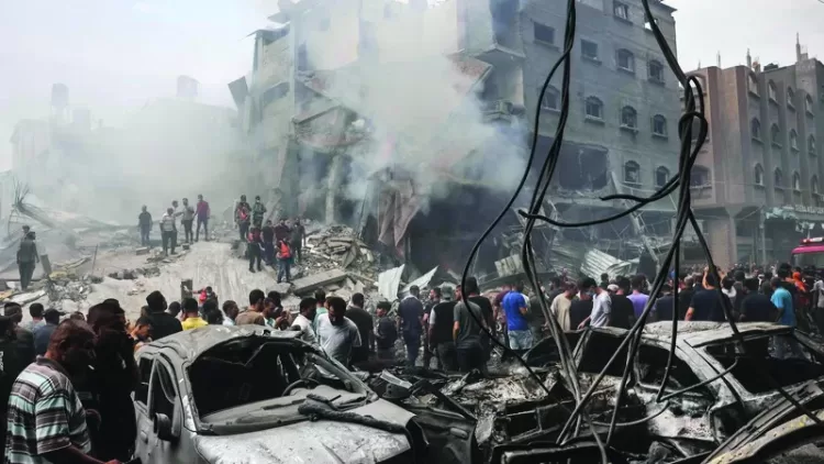 Palestinian search for survivors after an Israeli airstrike on buildings in the refugee camp of Jabalia in the Gaza Strip on October 9, 2023. Israel relentlessly pounded the Gaza Strip early Monday as fighting raged with Hamas around the Gaza Strip and the death toll from the war against the Palestinian militants surged above 1,100. (Photo by Mohammed ABED / AFP)