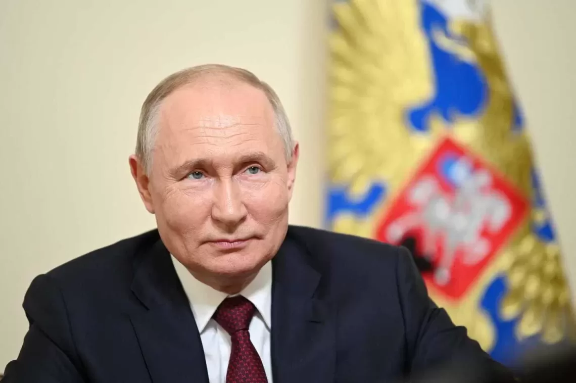 This pool image distributed by Sputnik agency shows Russian President Vladimir Putin holding a meeting with members of families awarded with the Order of Parental Glory via a videoconference call in Saint Petersburg on July 29, 2023. (Photo by Alexander KAZAKOV / POOL / AFP)