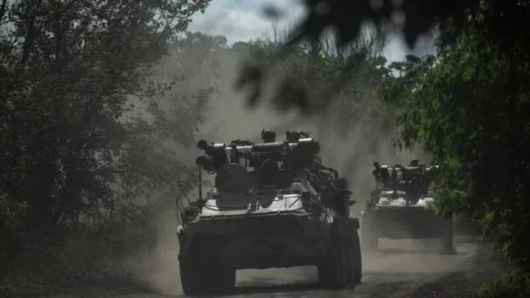 Ukrainian servicemen ride on armoured personnel carriers (APC) on a road toward Bakhmut, Donetsk region, on July 1, 2023, amid the Russian invasion of Ukraine. (Photo by Genya SAVILOV / AFP)