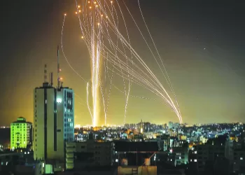 Rockets are launched from Gaza city, controlled by the Palestinian Hamas movement, in response to an Israeli air strike on a 12-storey building in the city, towards the coastal city of Tel Aviv, on May 11, 2021. (Photo by ANAS BABA / AFP)