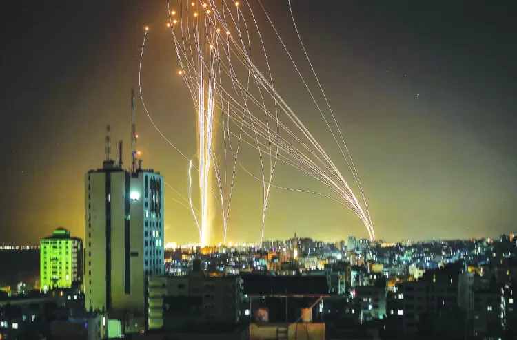 Rockets are launched from Gaza city, controlled by the Palestinian Hamas movement, in response to an Israeli air strike on a 12-storey building in the city, towards the coastal city of Tel Aviv, on May 11, 2021. (Photo by ANAS BABA / AFP)