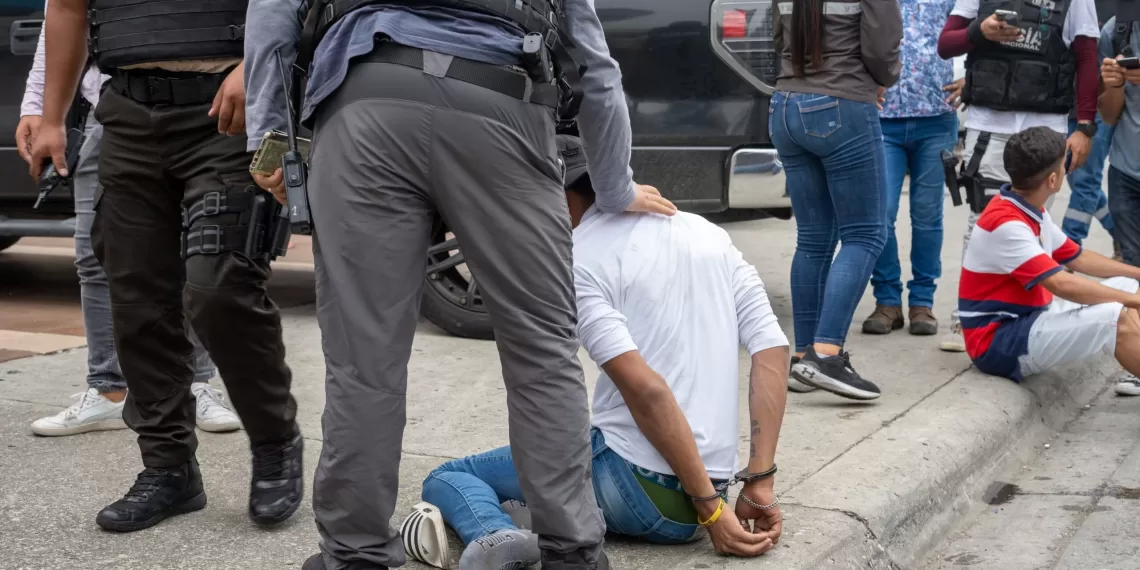 epa11066686 Police arrest a suspected criminal a few blocks from the headquarters of TC television station where armed, hooded men entered and subdued staff during a live broadcast, in Guayaquil, Ecuador, 09 January 2024. Agents of the National Police of Ecuador arrested at least thirteen people after entering the facilities of TC Television hours after a group of heavily armed men interrupted live programming, threatening employees with rifles, grenades and explosives.  EPA/Mauricio Torres
