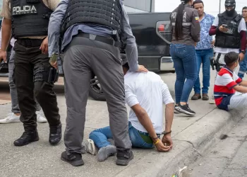 epa11066686 Police arrest a suspected criminal a few blocks from the headquarters of TC television station where armed, hooded men entered and subdued staff during a live broadcast, in Guayaquil, Ecuador, 09 January 2024. Agents of the National Police of Ecuador arrested at least thirteen people after entering the facilities of TC Television hours after a group of heavily armed men interrupted live programming, threatening employees with rifles, grenades and explosives.  EPA/Mauricio Torres